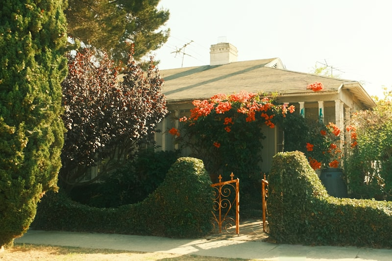Charming house with blooming spring flowers and well-maintained curb appeal