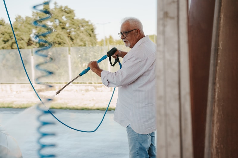 Man pressure washing an outdoor surface in Chandler